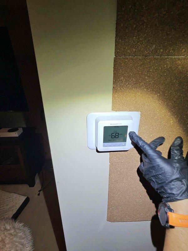 Replaced two UV bulbs in the HVAC system's air handler unit to restore proper air purification functionality. Verified system operation and confirmed thermostat was maintaining proper temperature setpoint at 68 degrees. Documentation photos were taken of the equipment and surrounding areas per customer request.