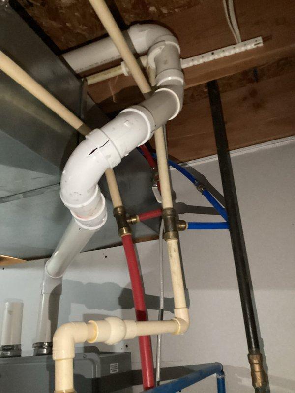 Responded to service call for tankless water heater not maintaining consistent hot water temperature. Upon arrival, inspected wall-mounted tankless unit and associated plumbing connections in mechanical room. Evaluated digital display panel for error codes and examined PVC venting system, copper supply lines, and PEX distribution piping. Assessed water flow, gas supply connections, and pressure readings at various points throughout the system. Documented existing installation configuration including water filtration equipment and multi-zone piping distribution network for diagnostic purposes.