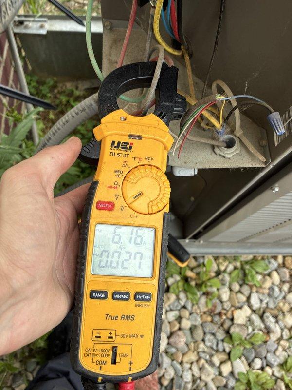 Completed comprehensive HVAC cooling and heating tune-up service on residential system. Performed temperature differential measurements using digital thermometer, recording 58.3°F reading at supply register to verify proper airflow and cooling performance. Conducted electrical diagnostics at outdoor condensing unit using clamp meter, measuring amperage draw of 6.16 amps and confirming proper electrical operation of compressor and fan motor circuits. Inspected all wire connections at junction box, verified proper voltage levels, and ensured all electrical components operating within manufacturer specifications. System found to be functioning properly with no deficiencies noted.