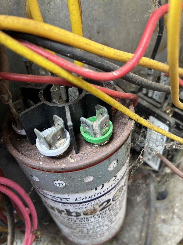 Responded to no cooling complaint where compressor motor was reportedly locking up. Upon inspection, found failed dual-run capacitor with visible deterioration and corrosion on terminals. Replaced defective capacitor, tested system operation, and verified compressor motor running properly with normal amp draw and cooling restored.