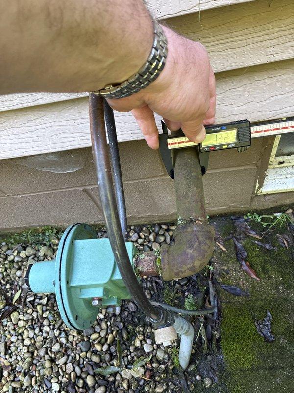 Conducted on-site evaluation for HVAC system replacement. Performed precise measurements of existing refrigerant line set using digital calipers, documenting pipe diameter at 12.7mm for proper equipment sizing and compatibility assessment. Assessed condition of outdoor unit components, noting significant corrosion and weathering on refrigerant lines and compressor housing, indicating need for complete system replacement. Provided customer with heat pump and air handler replacement options based on existing installation accessibility and equipment specifications.