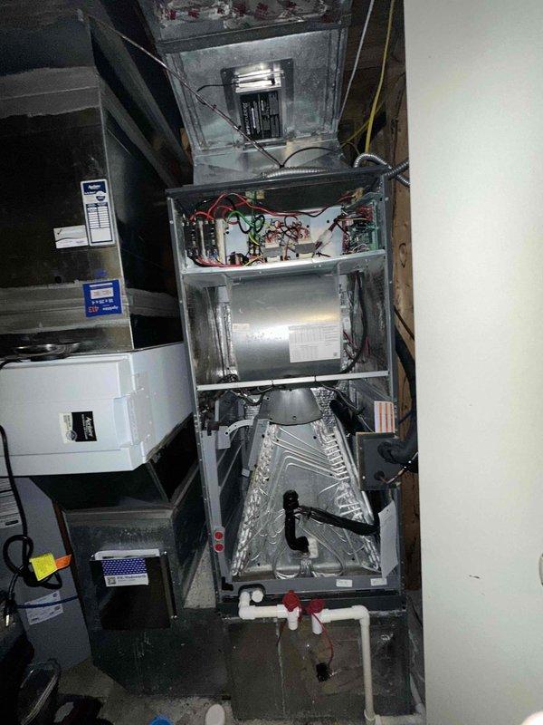 # HVAC Cooling System Maintenance

Completed routine preventive maintenance on residential split-system air conditioning unit. Performed comprehensive inspection of indoor air handler assembly, including electrical connections, control circuitry, and evaporator coil. Verified proper operation of all electrical components and wiring connections within the air handler cabinet. Inspected condensate drain system with PVC piping and confirmed proper drainage function.

Conducted thorough evaluation of outdoor condenser unit, which exhibited significant accumulation of dirt and debris on condenser coils. Coils showed heavy soiling with brownish-gray buildup affecting heat transfer efficiency. Inspected refrigerant line connections, electrical conduit, and unit mounting on concrete pad. Verified structural integrity of protective wire mesh guard and cabinet housing. All system components inspected and maintained per manufacturer specifications to ensure optimal cooling performance for the upc