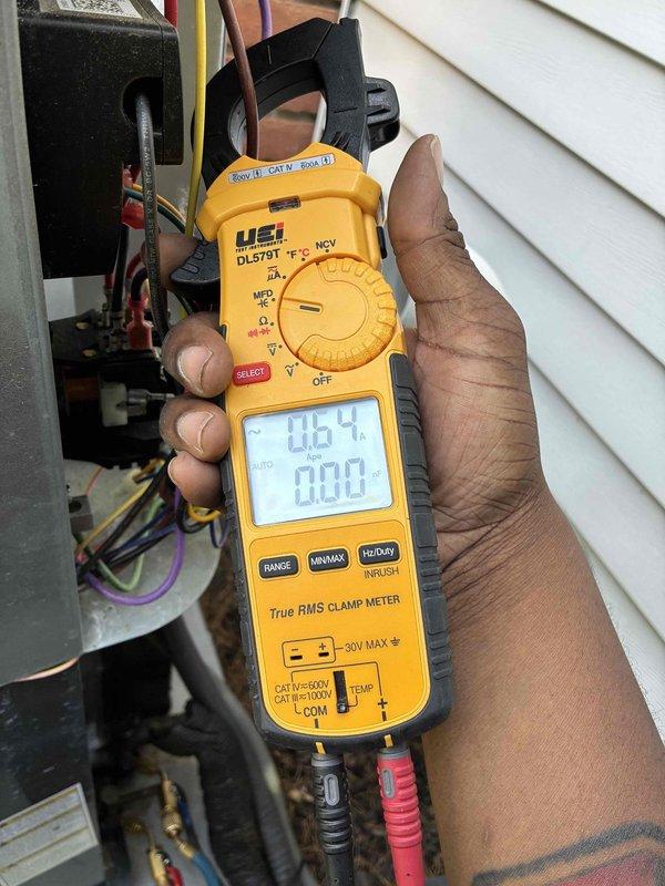 Performed routine cooling system maintenance on residential HVAC unit. Upon inspection, discovered significant accumulation of dust, dirt, and debris on evaporator coil fins, particularly concentrated in center and right sections which can restrict airflow and reduce system efficiency. Cleaned evaporator coil thoroughly to restore proper heat transfer capability. Conducted electrical diagnostics using clamp meter at outdoor unit, recording amperage readings of 46.4A and 0.08A to verify compressor and system component operation within manufacturer specifications. Inspected condensate drain line, electrical connections, and control board for proper function. System restored to optimal operating condition with improved airflow through clean coil assembly.