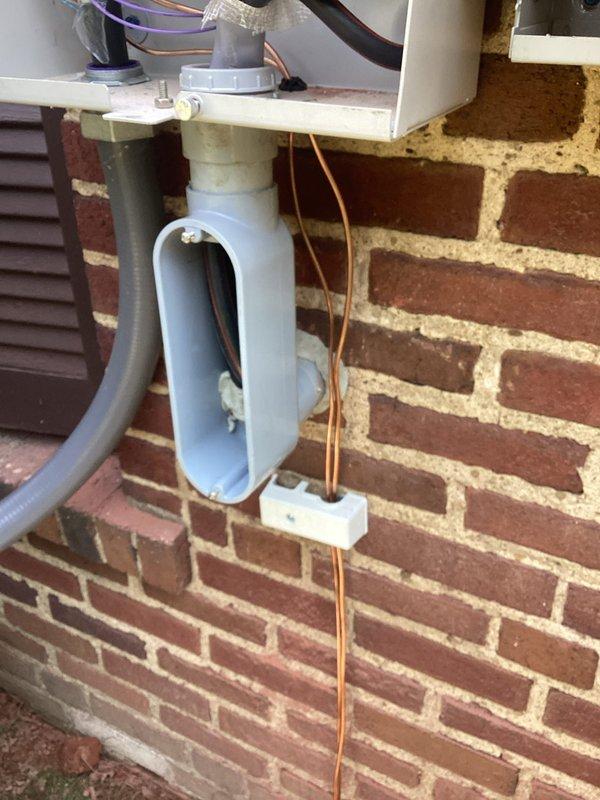Completed full residential backup power system installation including Generac whole-home generator mounted on concrete pad, 200-amp electrical service upgrade with new meter socket and panel, and whole-home surge protection device. Installation required coordination between electrical and plumbing trades, with new exterior conduit runs along brick exterior, proper generator transfer switch integration, and HVAC condensate drainage system accommodation to ensure all systems function safely together.