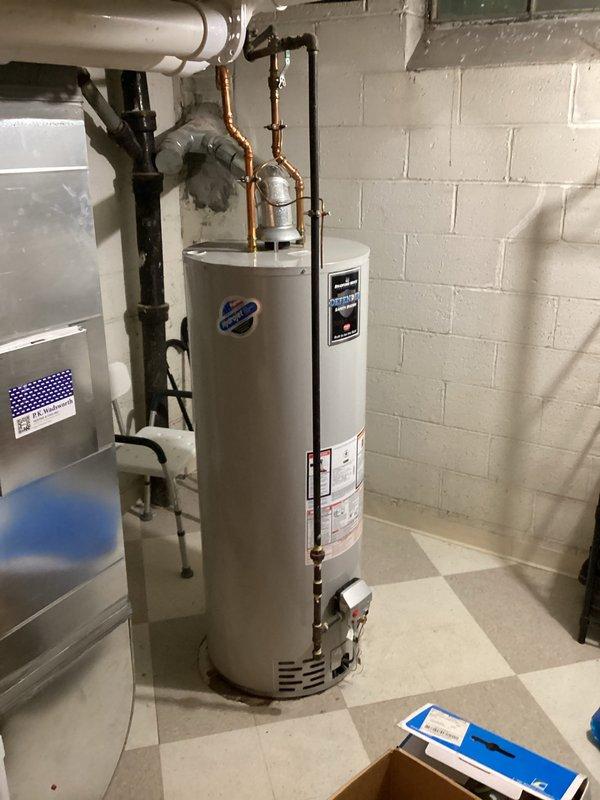 Completed scheduled plumbing maintenance visit for water heater fulfillment and inspection. Performed visual assessment of Bradford White automatic storage water heater unit, verifying proper installation, connections, and operational status. Documented equipment condition including copper piping connections, pressure relief valve, gas input specifications, and safety labeling compliance.