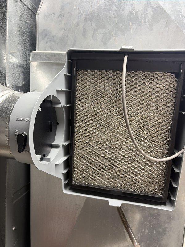 Performed routine HVAC cooling system maintenance including inspection of air handler unit and filter assembly. Filter showed moderate dust accumulation and was secured properly with existing mounting hardware. Verified damper control mechanism labeled for seasonal operation was functioning correctly, and all ductwork connections remained secure with no visible air leaks.