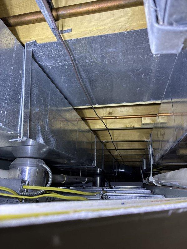 Conducted comprehensive assessment of existing HVAC system for replacement estimate. Evaluated 20-year-old heating and cooling equipment located in basement mechanical room, including furnace unit and associated ductwork distribution system throughout the property. Documented current system configuration, including air handler, plenum assembly, PVC drainage and venting infrastructure, and metal ductwork installation in attic space with supporting framework and insulation. Provided detailed replacement recommendations based on equipment age, system efficiency, and structural requirements for new installation.