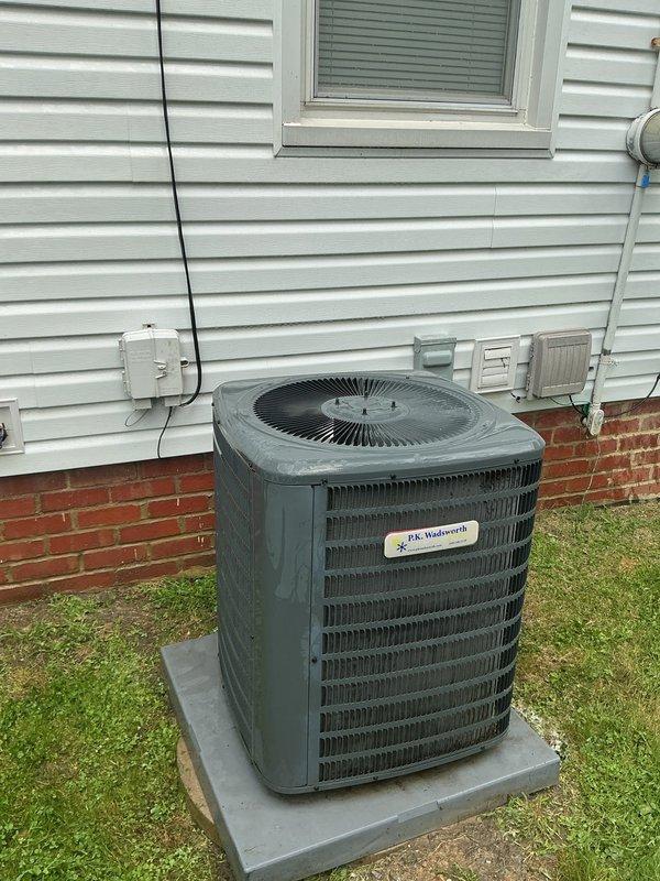 Responded to cooling complaint on 5-year-old Goodman system reported as blowing warm air. Upon arrival, performed diagnostic evaluation of outdoor condensing unit and indoor air handler. Inspected condenser unit positioned on concrete pad adjacent to structure, noting moisture present on exterior surfaces indicating recent operation. Verified electrical connections at junction box and conduit routing. Checked refrigerant pressures, compressor operation, and condenser fan motor performance. Tested system airflow through evaporator coil and verified thermostat settings and calibration. System found operating within normal parameters during service call with proper cooling output restored. Unit cycling correctly with appropriate temperature differential across coil. Advised occupant on proper thermostat operation and filter maintenance schedule to ensure continued efficient operation.