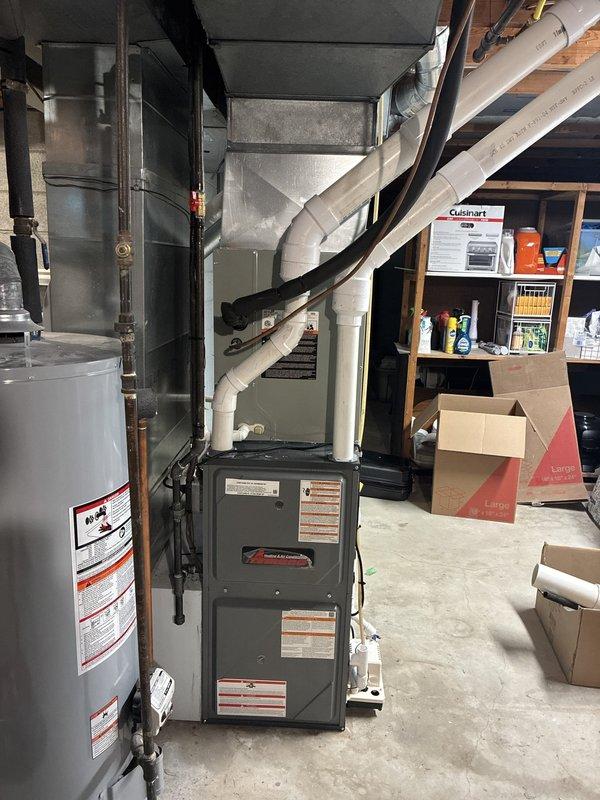 Completed installation of new 96% AFUE high-efficiency furnace in basement mechanical room. Connected all ductwork, installed PVC venting system, and verified proper operation of unit alongside existing water heater. All components tested and system commissioned successfully.
