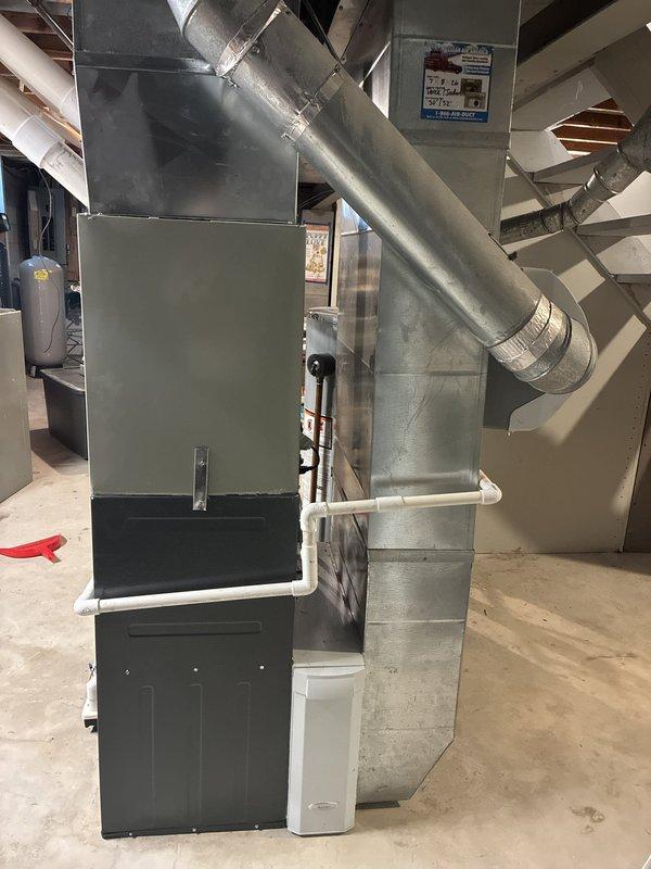Completed installation of new 96% AFUE high-efficiency furnace in basement mechanical room. Connected all ductwork, installed PVC venting system, and verified proper operation of unit alongside existing water heater. All components tested and system commissioned successfully.