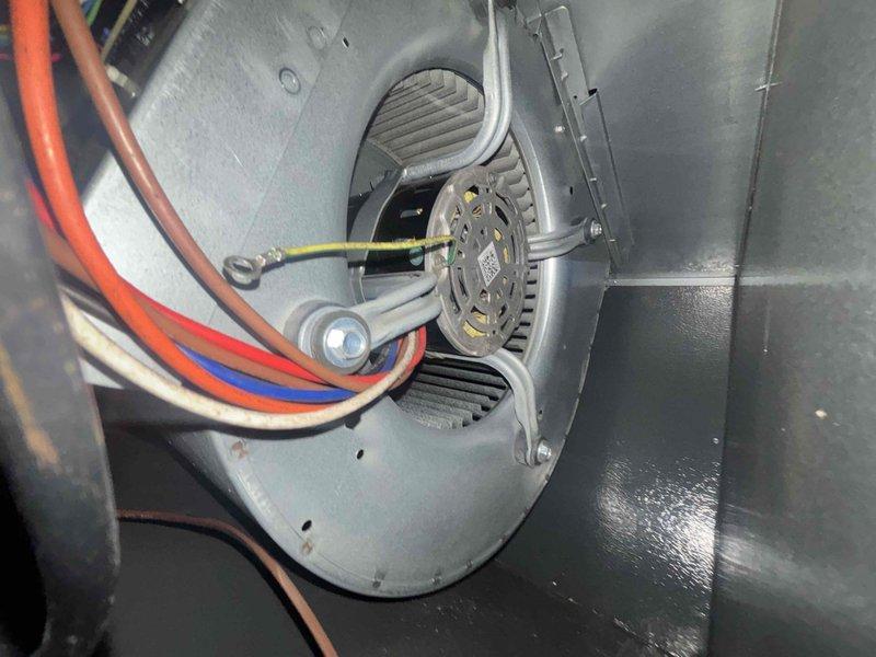 Completed scheduled cooling system maintenance visit on residential HVAC unit. Performed comprehensive inspection of air handler assembly, including blower motor, squirrel cage fan wheel, and electrical connections. Verified proper motor operation and measured electrical current draw using clamp meter, confirming amperage readings within manufacturer specifications at 0.04A. Inspected all wiring connections, including power leads and grounding wire, ensuring secure terminations and no signs of wear or overheating. Examined blower motor housing, mounting bracket, and surrounding ductwork for proper installation and structural integrity. All components found operating normally with no deficiencies noted. System returned to service in proper working condition.