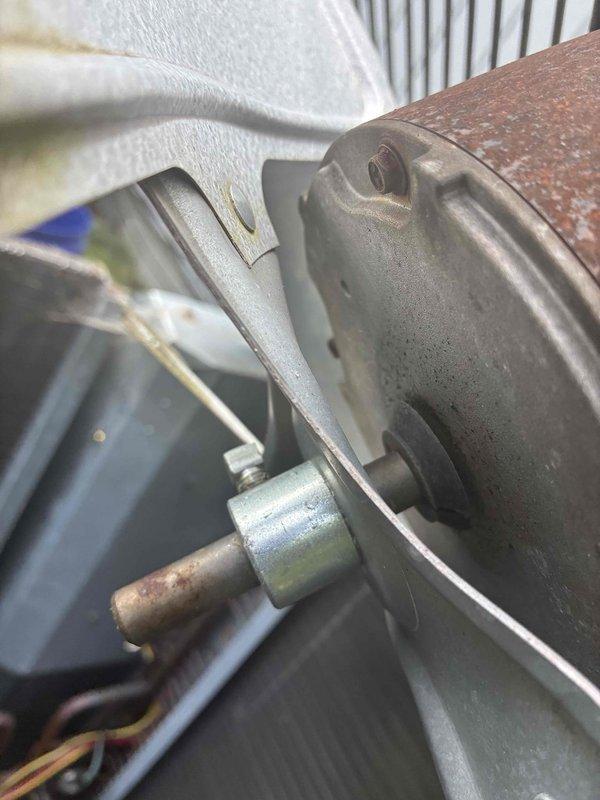 Completed routine HVAC cooling maintenance on aging system with furnace confirmed operational. Inspection revealed significant condenser coil contamination with heavy dust, dirt, and debris accumulation restricting airflow, along with cobweb buildup across fins indicating extended period without service. Blower motor assembly showed normal wear consistent with age, with surface corrosion noted on shaft but unit functioning properly.