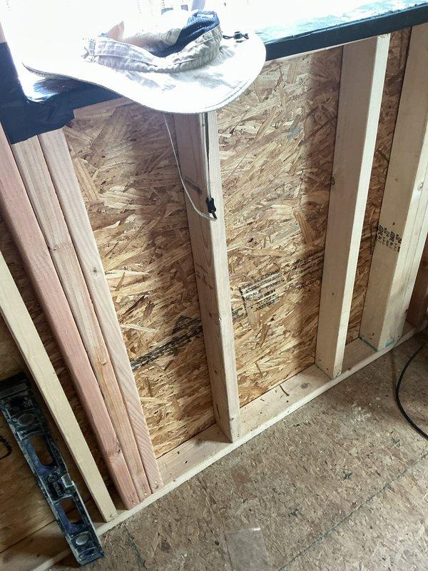 Performed electrical estimate for fixture installation and outlet verification in active residential renovation space. Assessed framing structure with exposed studs, OSB sheathing, and insulation to determine optimal placement for electrical outlets, switches, and lighting fixtures throughout the construction area. Coordinated with on-site contractor to evaluate electrical requirements for the project and documented existing conditions via photographs for estimate preparation.