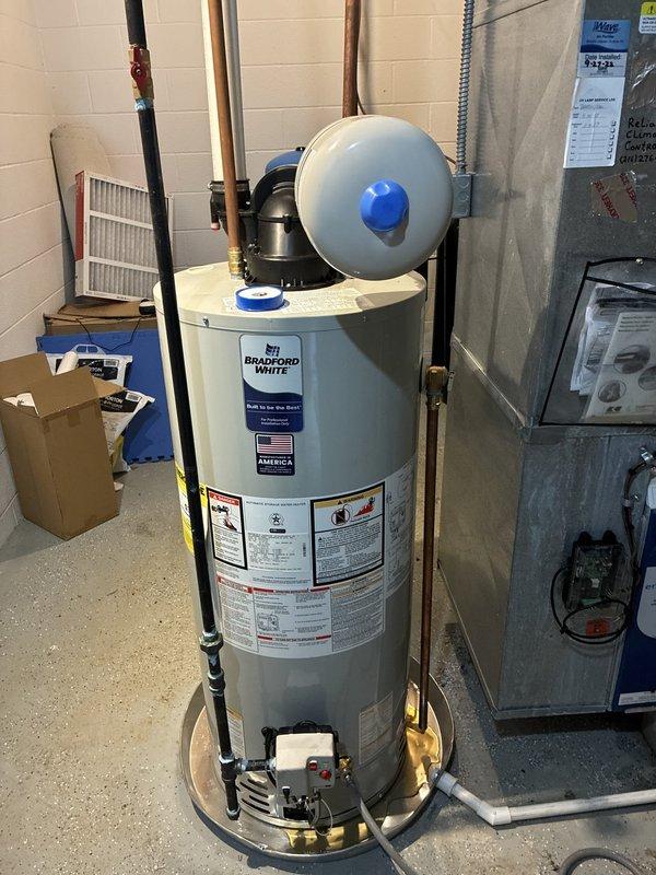 Completed installation of new air conditioning system and 40-gallon power vent water heater. Successfully installed Bradford White power vent water heater with proper venting configuration, gas line connections, and leak protection pan. Connected all necessary copper and black iron piping to unit specifications, ensuring compliance with manufacturer requirements and local codes. AC system installed and operational, with all refrigerant lines, electrical connections, and condensate drainage properly configured.