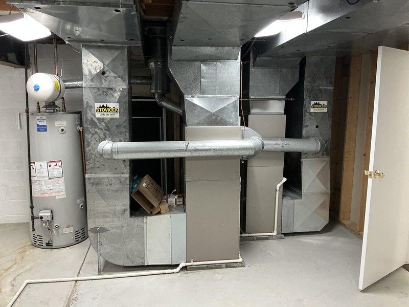Conducted on-site assessment of existing dual-zone HVAC system in basement mechanical room to provide replacement options for aging equipment. Documented current configuration including two furnace units with associated ductwork, evaluated system layout and spatial constraints, and photographed existing installation to develop comprehensive replacement proposals for the customer's consideration.