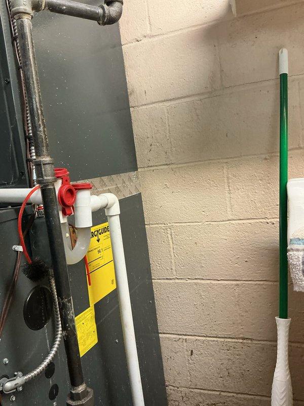 Responded to customer complaint of odor in home when air conditioning system operates. Performed thorough inspection of HVAC system including furnace unit and associated components. Examined air handler, ductwork connections, and PVC condensate drain lines with shutoff valves for potential sources of odor. Documented existing system configuration and condition with photographs for service records.