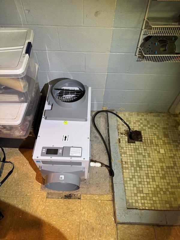Returned to property to complete installation of portable dehumidifier unit in basement utility area. Unit was positioned on existing flooring, connected to power supply, and tested to verify proper operation of all controls and functions.