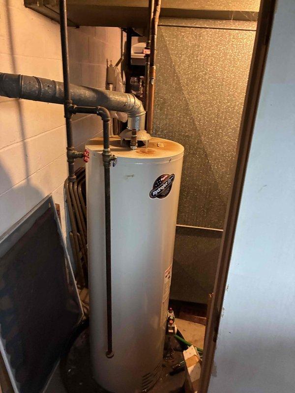 Installed 50-gallon residential water heater with expansion tank in basement utility area. Completed all necessary plumbing connections including hot and cold water lines with shutoff valves, and ensured proper integration with existing HVAC and plumbing systems. Unit is fully operational and tested for proper function.