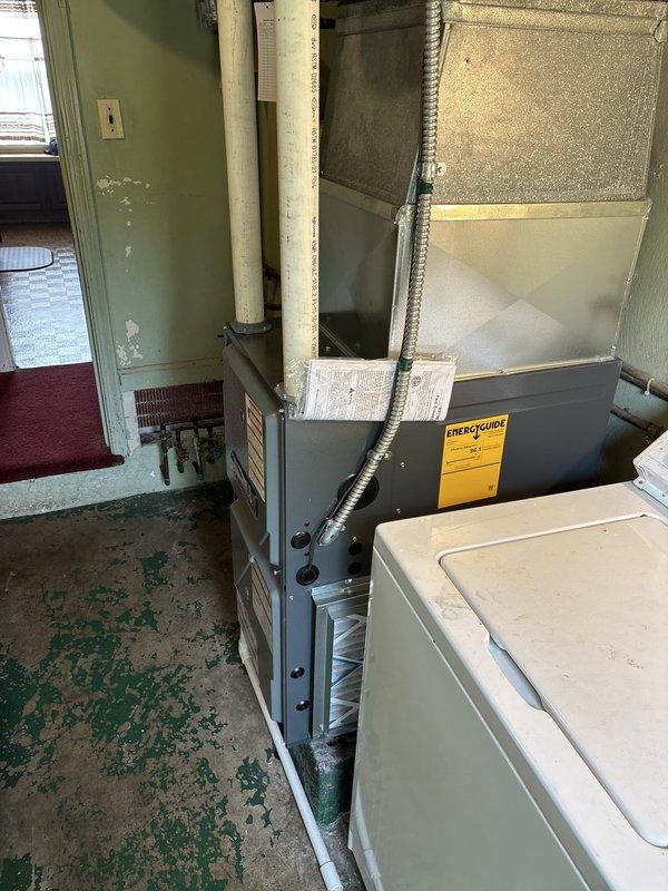 Completed installation of 96% efficiency furnace system in residential basement utility area. Unit was properly positioned, vented with metallic ductwork, and connected to existing air handler system. Customer requested technician wait on-site for their arrival before finalizing installation. All equipment tested and operational upon completion.