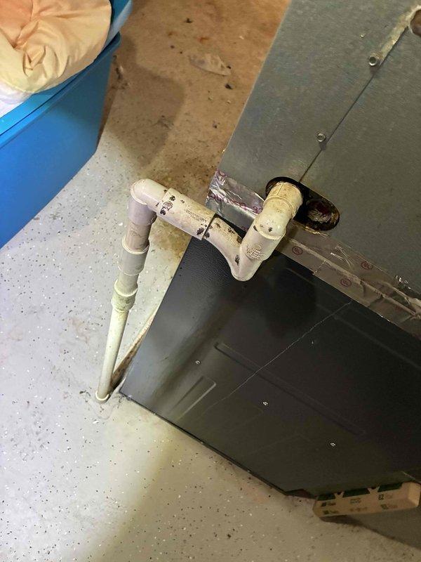 Responded to service call for air conditioning system leaking water in basement. Upon inspection, found condensate drain line with signs of blockage and extensive corrosion on evaporator coil housing and refrigerant lines, indicating prolonged moisture exposure. Cleared condensate drain obstruction, verified proper drainage flow, and advised customer of deteriorated equipment condition requiring future attention to prevent recurring issues.