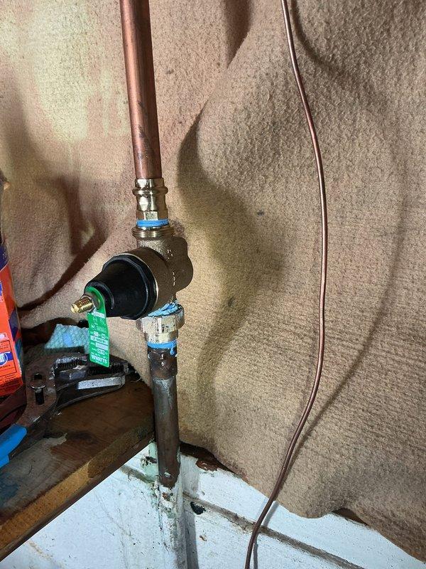 Responded to callback for leaking valve on hot water heater that was recently replaced. Upon arrival, inspected the brass valve assembly and compression fittings connecting to the water heater inlet. Identified active leak at valve connection point. Tightened compression fittings and verified proper seating of all connections. Tested system under pressure to confirm leak was resolved and all joints remained dry during operation.