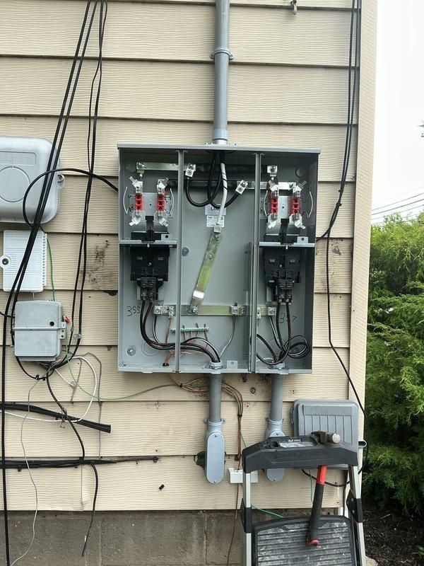 Completed a comprehensive 100-amp electrical service upgrade involving replacement of both the exterior meter panel and interior main distribution panel. Installed new meter base with dual metering capability, main disconnect breaker rated at 50kA interrupting capacity, and organized circuit breaker distribution with proper color-coded wiring throughout. Ran 1½-inch PVC conduit for service entrance conductors, established proper grounding and bonding connections, and ensured all components met current NEC standards for residential electrical service installations.