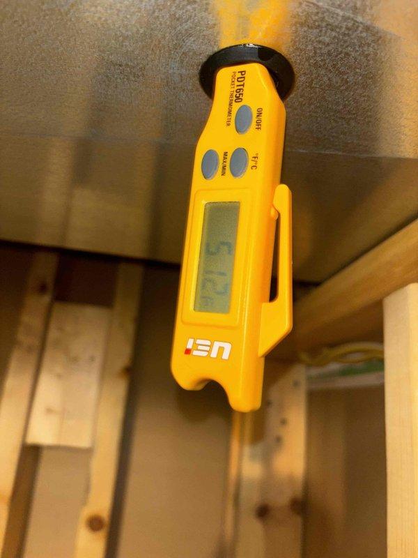 Completed routine HVAC cooling maintenance inspection on residential system. Inspected and photographed capacitor connections and wiring within the condensing unit, noting dust accumulation on components but confirming proper electrical connections remain secure. Performed moisture detection testing in attic space near air handler using pinless moisture meter to verify no water intrusion or condensate issues present in insulation or surrounding structure.