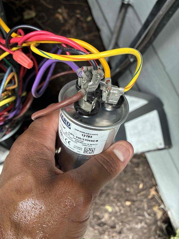Responded to no-power complaint on residential air conditioning system. Upon inspection, diagnosed failed run capacitor preventing compressor and condenser fan operation. Removed defective capacitor, tested specifications with digital multimeter, and installed replacement 370VAC capacitor with proper wire connections. Verified system startup and confirmed normal operation restored.