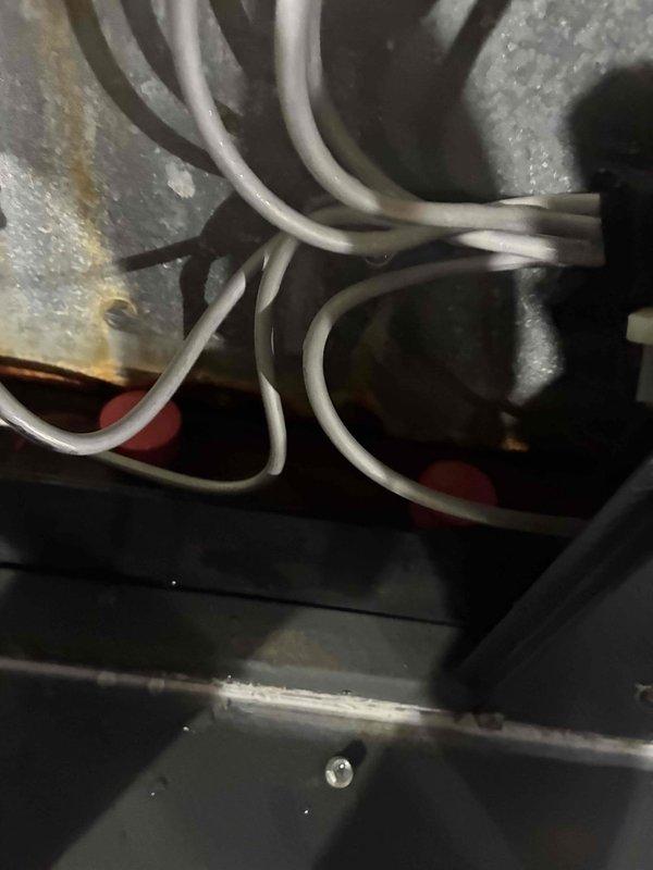 # HVAC Repair - Water Discharge from Furnace

Responded to service call for water leaking from furnace on 9-year-old HVAC system. Upon inspection, identified condensate drainage issue affecting the cooling system operation.

## Work Performed

Accessed the furnace cabinet and inspected the evaporator coil assembly and condensate management system. Found standing water accumulated in the drain pan beneath the evaporator coil, indicating a blocked or restricted condensate drain line. Examined the primary drain line routing and connection points for obstructions.

Verified condensate pump operation and float switch functionality where applicable. Inspected secondary drain pan for proper installation and overflow protection. Checked the evaporator coil for excessive dirt buildup that could contribute to condensate overflow conditions.

Cleared the condensate drain line blockage using appropriate methods to restore proper water discharge. Verified proper drainage flow and tested system oper