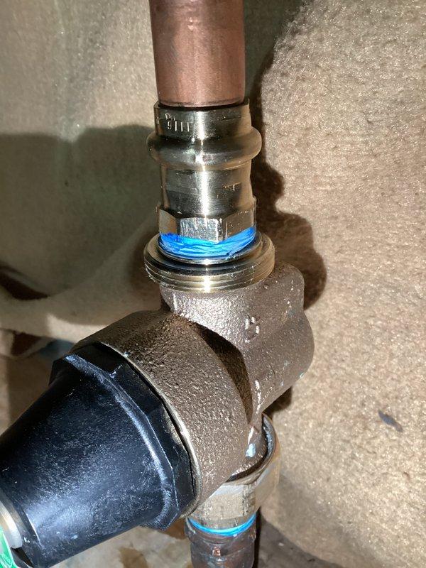 Responded to callback for leaking plumbing connection. Upon inspection, identified active leak at brass elbow fitting assembly with visible moisture condensation throughout the connection points. Repaired faulty threaded connections, replaced compromised O-rings at upper and lower connection points, and resealed joints with appropriate threadlocker compound. Verified all fittings were properly tightened and tested system for leaks under pressure. Connection assembly now functioning properly with no visible leakage.