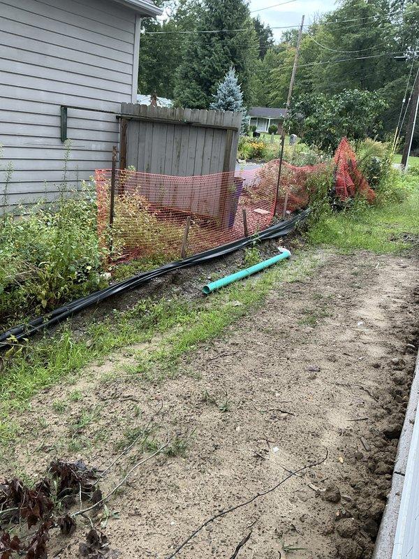 Completed electrical estimate for residential generator installation. Customer has existing hook-up components on-site. Evaluated current electrical service panel and meter configuration mounted on exterior wall, including existing transfer switch with ON/OFF capability. Assessed backyard installation area where underground utility work is in progress, noting PVC conduit and drainage lines already positioned for generator pad placement. Documented existing electrical infrastructure and site conditions to provide accurate estimate for generator connection and final installation requirements.
