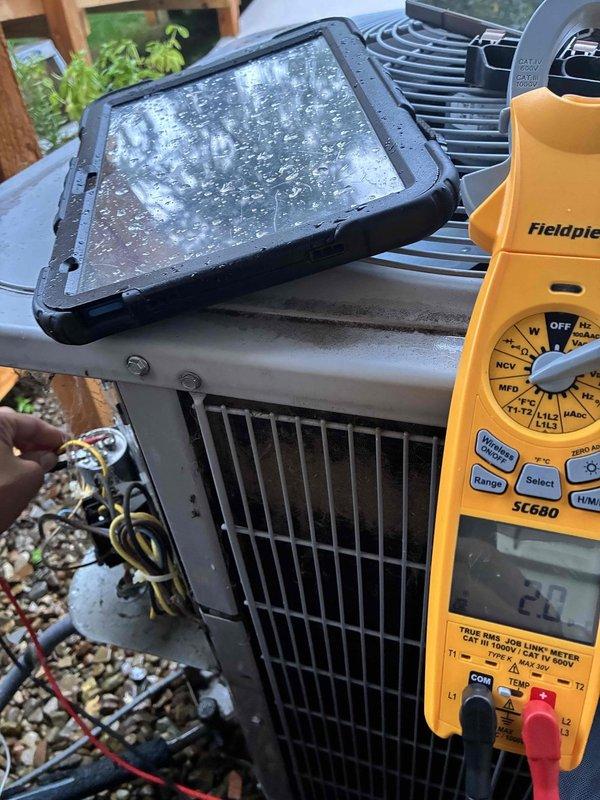 Responded to service call for Carrier air conditioning unit experiencing intermittent condenser fan operation. Upon arrival, performed diagnostic testing of the outdoor condenser unit using digital multimeter. Measured capacitor microfarad reading of 21 MFD, which indicated capacitor failure as the original specification was significantly higher. Further testing confirmed voltage readings of 34.3 volts at the fan motor terminals. Diagnosed failed run capacitor as root cause of condenser fan shutting off prematurely. Replaced defective dual run capacitor with properly rated OEM replacement part. Verified correct microfarad ratings for both compressor and fan motor circuits. Tested system operation through complete cooling cycle to ensure condenser fan maintained continuous operation without interruption. System restored to normal operating condition with proper airflow across condenser coil.