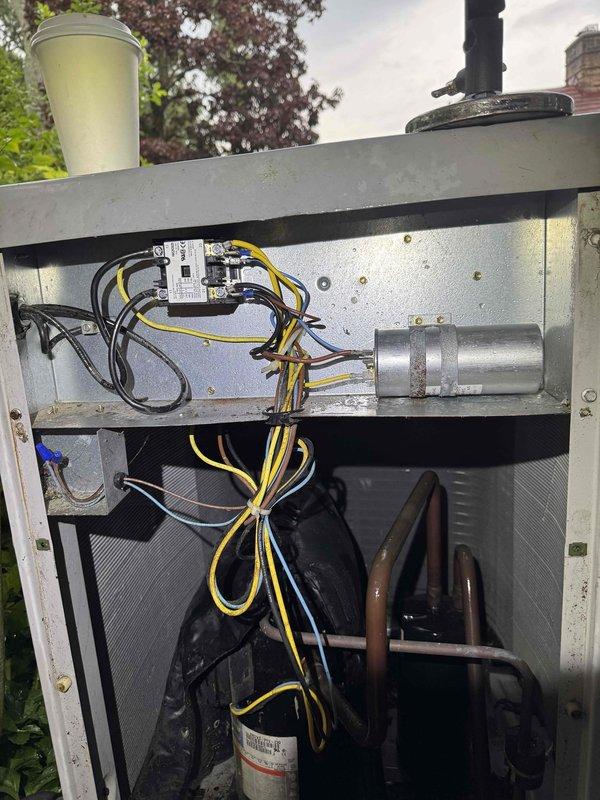Responded to no cooling call at residential property. Upon arrival, found outdoor condenser unit heavily overgrown with vegetation restricting airflow. Removed access panel and performed system inspection. Identified non-functional compressor and contactor requiring replacement. Cleared vegetation from around unit to restore proper airflow and accessibility for service. System evaluated and customer advised of necessary repairs to restore cooling operation.