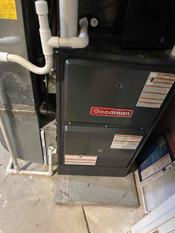 Responded to service call for loud buzzing noise on recently installed Goodman air conditioning system. Upon arrival, performed diagnostic inspection of indoor furnace unit and blower motor assembly. Identified issue with blower motor experiencing mechanical noise during startup cycles. Inspected motor mounting, bearings, and fan wheel assembly for loose components or obstructions. Verified proper electrical connections and capacitor function. Documented equipment condition with photographs showing furnace installation and blower motor assembly details. Unit is under manufacturer warranty coverage. Provided customer with findings and recommended contacting warranty service for authorized motor replacement or repair to resolve buzzing noise issue.