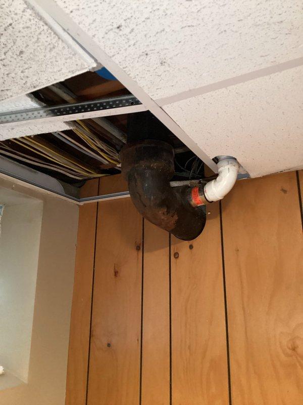 Responded to emergency plumbing call for multiple active leaks including water heater, basement stack pipe, and additional piping systems. Upon inspection, documented severely corroded metal stack pipe with extensive rust deterioration and compromised structural integrity. Also identified leaking PVC drainage connections in ceiling cavity with visible water damage. Assessed all leak sources and provided recommendations for immediate repairs to prevent further water damage to property.