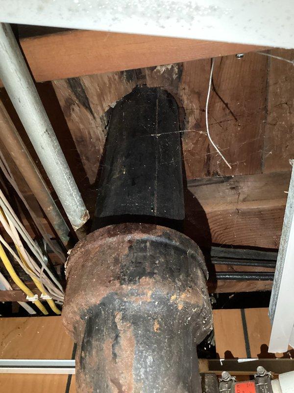 Responded to emergency plumbing call for multiple active leaks including water heater, basement stack pipe, and additional piping systems. Upon inspection, documented severely corroded metal stack pipe with extensive rust deterioration and compromised structural integrity. Also identified leaking PVC drainage connections in ceiling cavity with visible water damage. Assessed all leak sources and provided recommendations for immediate repairs to prevent further water damage to property.