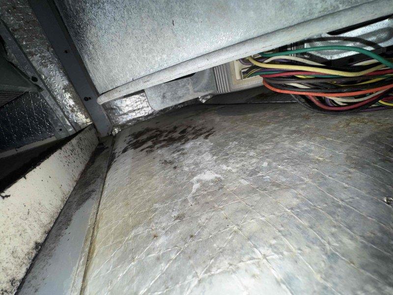 Responded to service call for system running continuously without responding to thermostat commands. Upon inspection, found extensive frost and ice buildup on evaporator coil in attic air handler unit. Diagnosed frozen coil condition causing system to run non-stop despite thermostat input. Identified restricted airflow and possible low refrigerant charge as contributing factors. Thawed evaporator coil, verified proper airflow through system, and checked refrigerant levels. System restored to normal operation with proper cycling control through thermostat.