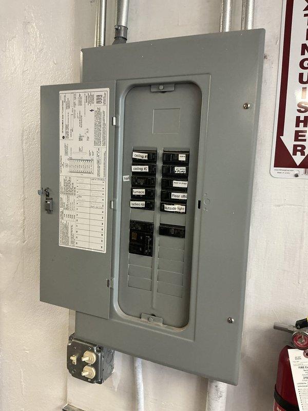Conducted site assessment for commercial heating system replacement estimate. Documented existing electrical infrastructure including main breaker panel configuration and available circuits to determine power requirements for new heating equipment. Inspected exterior mechanical area and existing HVAC equipment location, noting building access points and installation pathway considerations for equipment replacement.