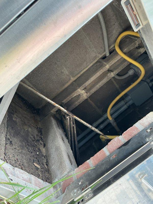 Responded to service call regarding two non-functional circuits following knob and tube rewiring project. Customer reported that these circuits served infrequently used areas and had been previously advised that some circuits might require additional work post-rewire. Inspected outdoor electrical fixtures and associated wiring in crawlspace and exterior locations, documenting existing conditions including HVAC ductwork proximity, outdoor brick grill structure with electrical components, and accessible wiring pathways for troubleshooting and future remediation.