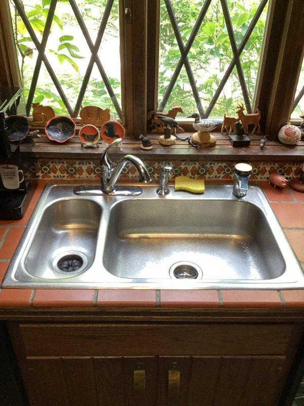 Responded to service call for faucet repairs at residential property. Serviced one kitchen faucet at double-basin stainless steel sink and two bathroom faucets at double vanity with chrome fixtures. Inspected all three faucet assemblies for leaks, worn components, and operational issues. Replaced deteriorated washers, O-rings, and cartridges as needed. Tested water flow and temperature control at all fixtures to ensure proper function. Verified no leaks at base or handles upon completion. All faucets restored to full working order.