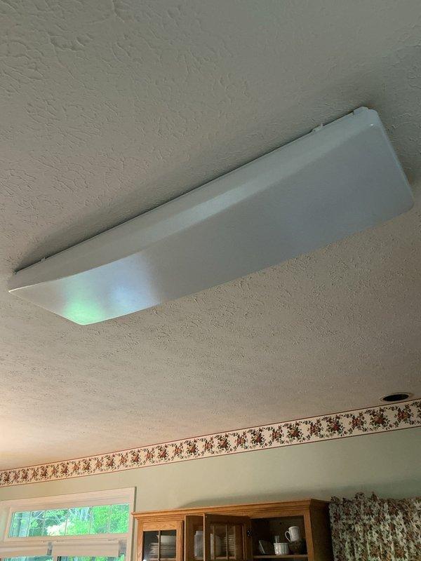 Responded to service call for non-functioning kitchen ceiling fluorescent light fixture. Customer had already replaced bulbs and cycled the circuit breaker without success. Upon inspection, diagnosed faulty ballast in the recessed fluorescent fixture. Replaced defective ballast with compatible unit, tested fixture operation, and confirmed proper illumination restored. Fixture now operating normally.