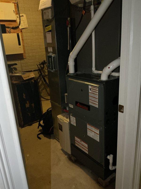 Completed comprehensive cooling maintenance on aging HVAC system as part of ongoing preventive maintenance program. Performed full system inspection of furnace and air conditioning components in basement mechanical room, verified operational parameters, and documented temperature differential readings of 25.4 degrees, indicating proper cooling performance. All equipment photographed and confirmed to be functioning within manufacturer specifications for continued reliable operation.