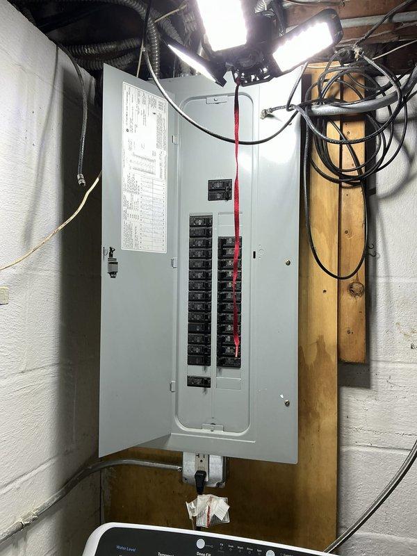 Conducted on-site evaluation for backup generator installation at residential property. Assessed existing 200-amp electrical service panel located in basement utility area and evaluated current electrical infrastructure including circuit breaker configuration, available panel capacity, and wire routing pathways. Documented mechanical room layout, existing appliance loads, and structural considerations for generator transfer switch placement. Photographed electrical panel specifications, ceiling-mounted conduit runs, and available wall space for transfer switch installation. Evaluated exterior access points and determined optimal generator pad location relative to existing gas lines and electrical service entrance. Prepared comprehensive material and labor estimate for automatic transfer switch installation, generator pad preparation, and required electrical connections to integrate standby power system with existing residential electrical distribution.