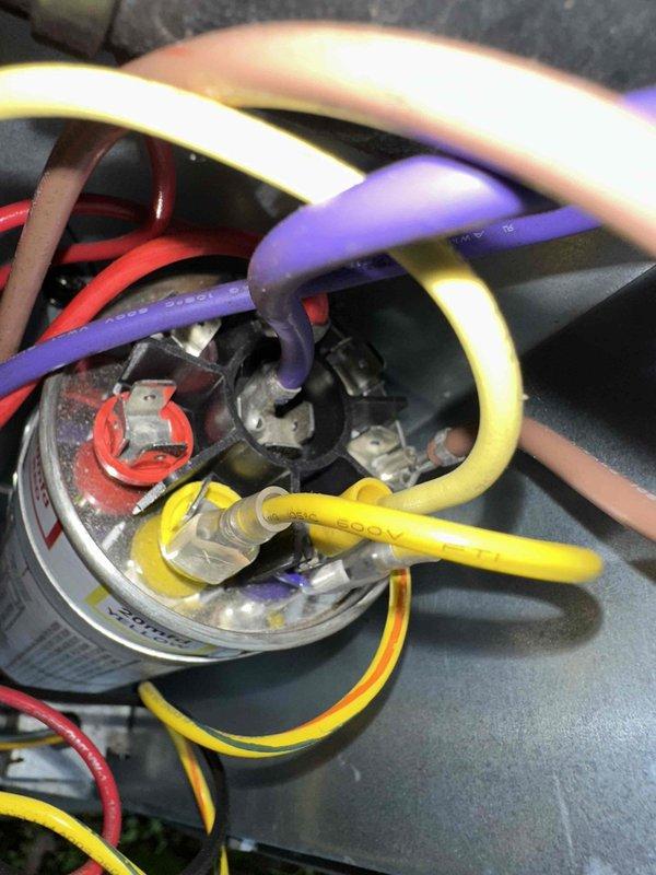 Completed scheduled preventative maintenance on residential cooling system. Replaced dirty air filter with new pleated filter to ensure proper airflow and system efficiency. Inspected and verified electrical connections on capacitor, confirming all wire terminals are secure and system is operating within normal parameters.