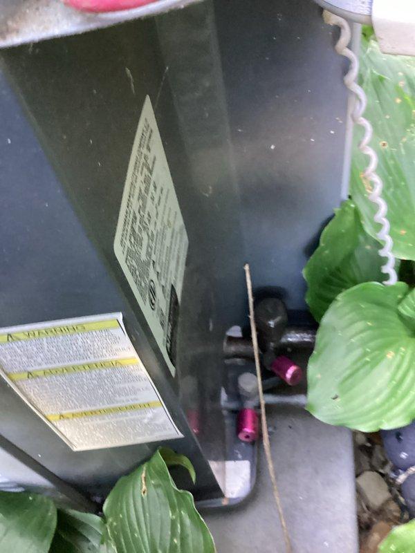 Performed routine HVAC tune-up on residential air conditioning system. Upon inspection, discovered significant frost and ice buildup on evaporator coil and clear access panel, indicating potential airflow restriction or refrigerant issue. Documented equipment condition with photos showing outdoor condensing unit and indoor coil assembly for service records.