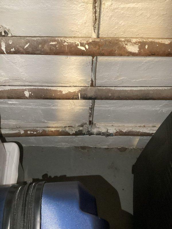 Responded to service call for corroded copper piping connected to boiler system. Upon inspection, identified severely deteriorated copper pipes with extensive oxidation, corrosion, and surface degradation on overhead plumbing infrastructure. The uppermost pipe exhibited the most critical deterioration with white and brown discoloration indicating advanced corrosion. Documented conditions with photographs showing compromised pipe integrity requiring repair or replacement to prevent potential leaks and system failure.