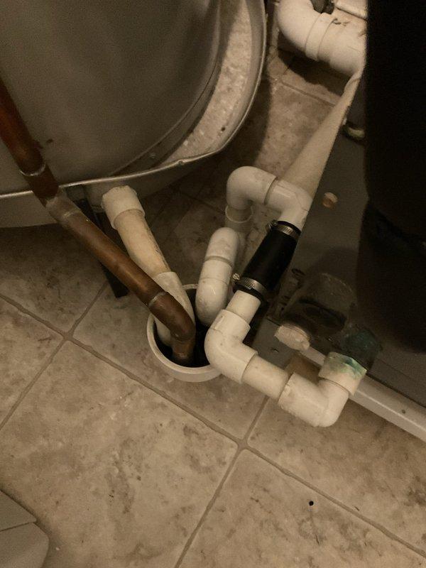 Responded to service call for clogged air conditioning condensate drain line. Upon inspection, located blockage in PVC drain system beneath bathroom fixture. Cleared obstruction from condensate drain line, verified proper drainage flow, and tested system operation to ensure condensate was draining freely without backup.