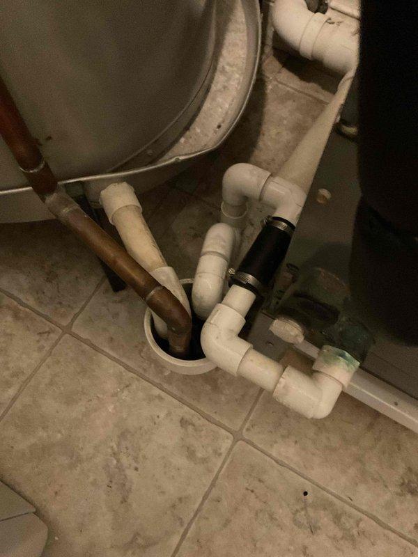 Responded to service call for clogged air conditioning condensate drain line. Upon inspection, located blockage in PVC drain system beneath bathroom fixture. Cleared obstruction from condensate drain line, verified proper drainage flow, and tested system operation to ensure condensate was draining freely without backup.
