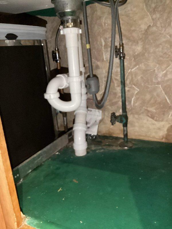 Installed new Moen pull-down kitchen faucet with brushed nickel finish and large white single-basin granite sink with integrated drainboard section in existing countertop opening. Connected all supply lines, drain assembly with P-trap, and verified proper operation of all components with no leaks detected.