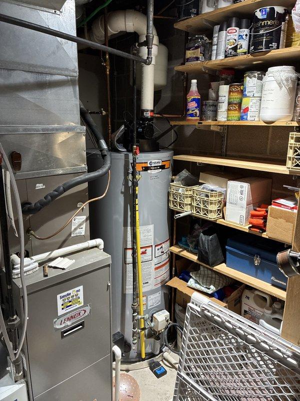 Completed first call estimate for full HVAC system replacement involving two complete systems. Assessed existing Lennox furnace and water heater installation located in basement utility area. Evaluated current equipment configuration, ductwork routing, and utility connections including electrical conduits and plumbing vents passing through structural framing. Documented existing system layout, equipment accessibility, and mechanical room conditions to prepare comprehensive replacement proposal for dual system installation.